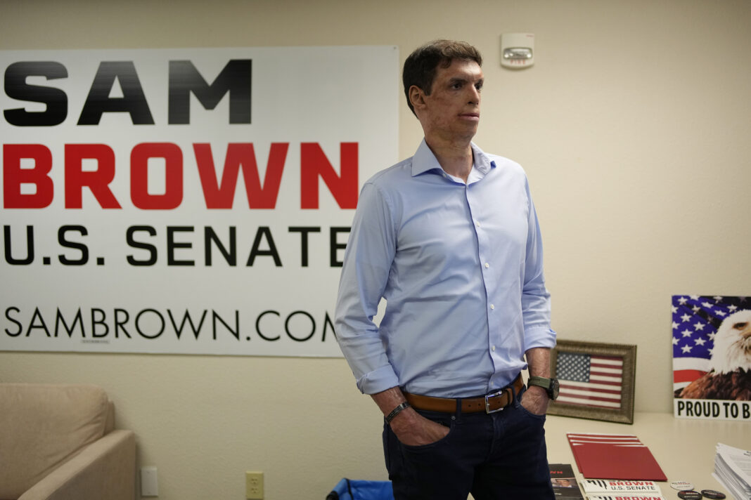Nevada Republican Senate hopeful Sam Brown, a retired Army captain and Purple Heart recipient, stands in a campaign office Tuesday, June 14, 2022, in Las Vegas. Brown made his long-awaited U.S. Senate candidacy official on Monday, July 10, 2023, jumping into the race to take on Democratic incumbent Jacky Rosen a year after losing the Republican nomination to challenge Nevada's other U.S. senator. (AP Photo/John Locher, File)