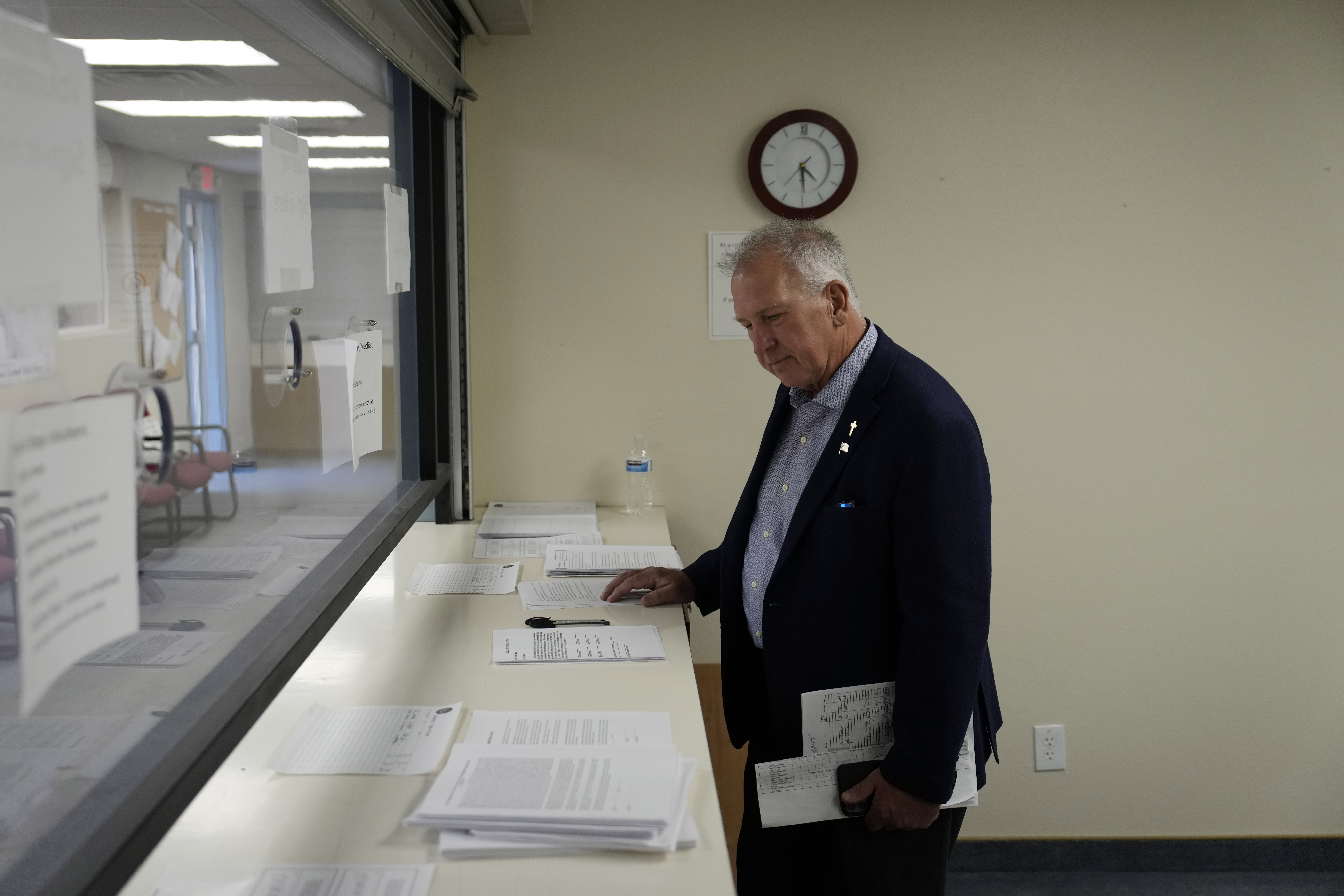 FILE - Interim Nye County Clerk Mark Kampf works in an office where early votes are being counted, Oct. 26, 2022, in Pahrump, Nev. Kampf, top elections official in the rural Nevada county roiled by false claims of widespread election fraud that led to a partial hand-count in the 2022 midterms, is resigning, a county spokesperson confirmed Thursday, Feb. 29, 2024. (AP Photo/John Locher, File)