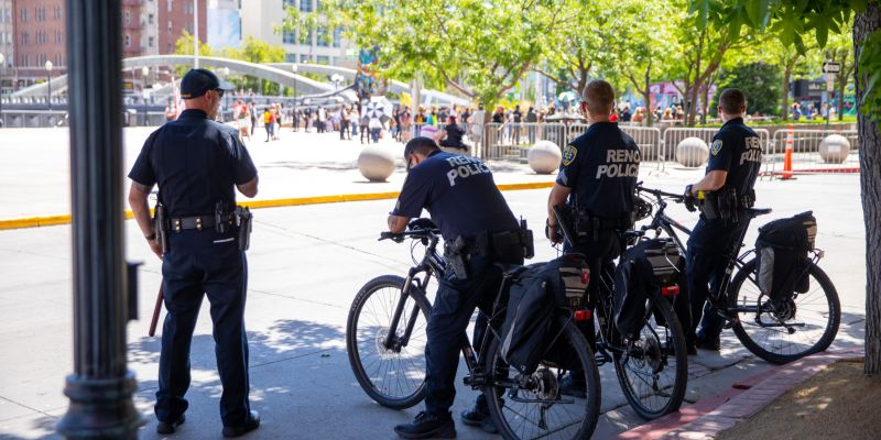 Reno Police sat quietly in the shade and monitored a peaceful protest against Immigration and Customs Enforcement in downtown Reno on June 20, 2020. Image: Eric Marks / This Is Reno