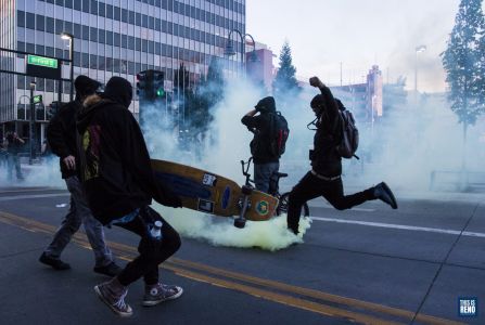 Rioters kick gas canisters back toward police. Image: Ty O'Neil