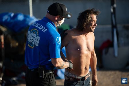 A Reno Ambassador greets a man living in a camp in downtown Reno.