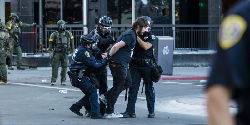 Police arrest a rioter in downtown Reno. Image: Ty O'Neil