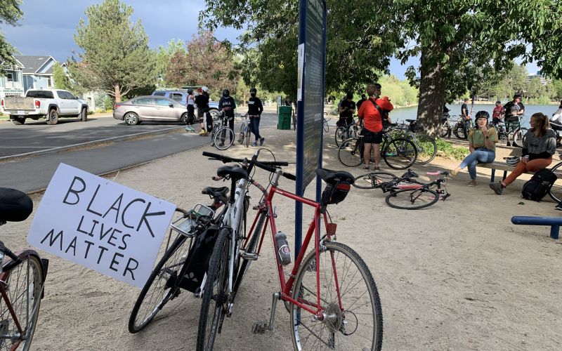 A protest sign on a bike at Virginia Lake. Image: Lucia Starbuck
