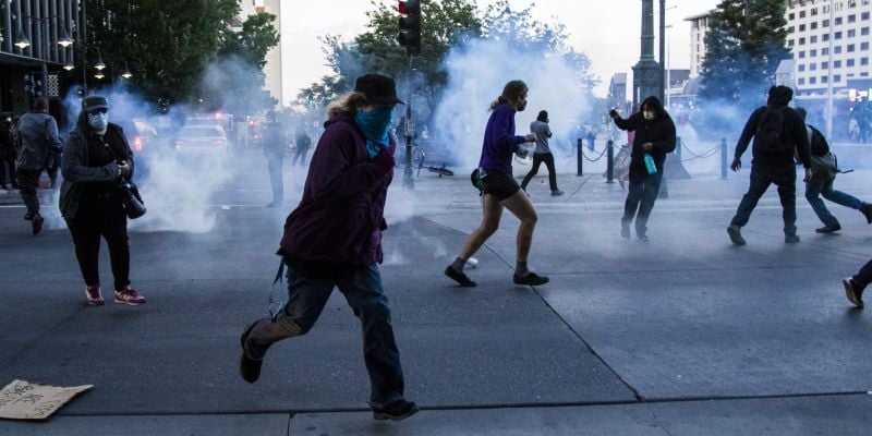 Rioters flea from plumes of tear gas in downtown Reno. Image: Ty O'Neil