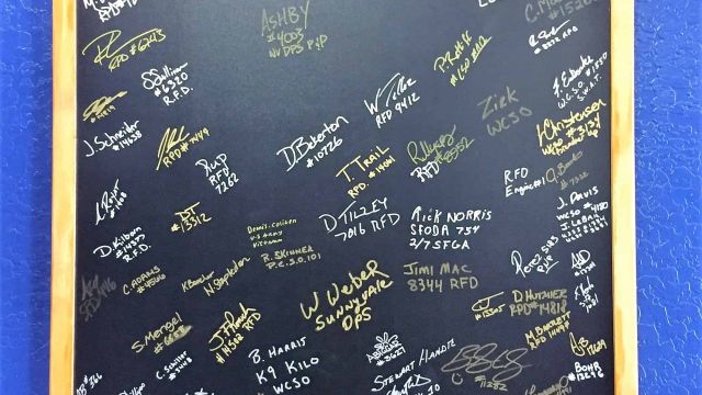 Blackboard with signature of local first responders at Code Coffee
