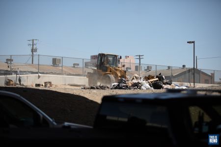 A bulldozer was brought in to clean up the site of a homeless encampment in downtown Reno. Image: Isaac Hoops