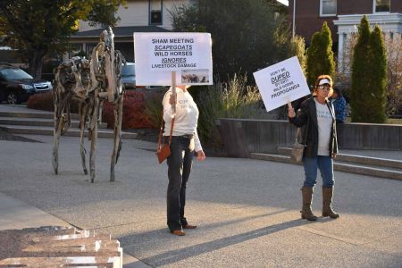 Picketers protest outside the Nevada Museum of Art before the "Horse Rich & Dirt Poor" film screening and forum discussion.