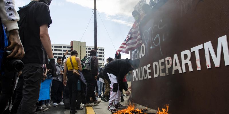 Rioters vandalize the Reno Police Department's headquarters. Image: Ty O'Neil