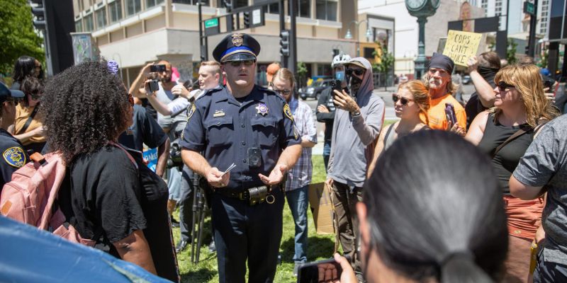 Reno Police officers arrived where advocates were protesting homeless camp sweeps at City Plaza on June 7, 2021.