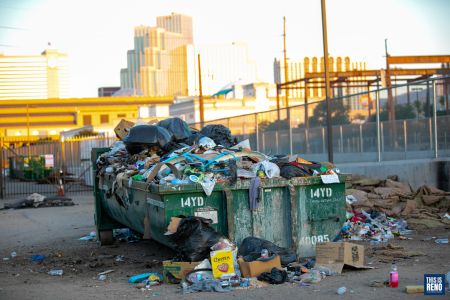 A dumpster of trash overflowed near a homeless camp in downtown Reno. Image: Eric Marks