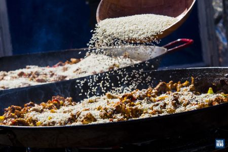 Rice is added to a pan of paella during the Reno Paella Cookoff on Sept. 12, 2021 at Battle Born Beer in Reno, Nev.