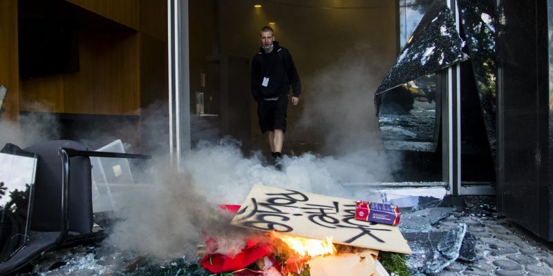 Protesters set a fire outside a heavily damaged City Hall. Image: Ty O'Neil