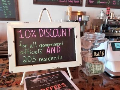 Discount sign for gov officials and building tenants at The Mug Shot Coffee & Eatery
