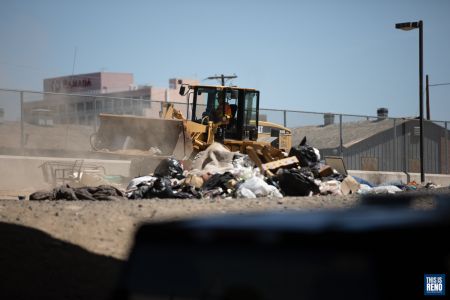 A bulldozer was brought in to clean up the site of a homeless encampment in downtown Reno. Image: Isaac Hoops