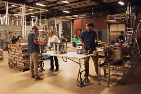 Workers pack cases of Battle Born Beer