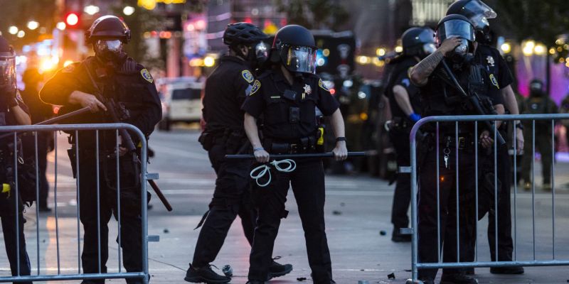 Protesters and police clash in downtown Reno. Image: Ty O'Neil